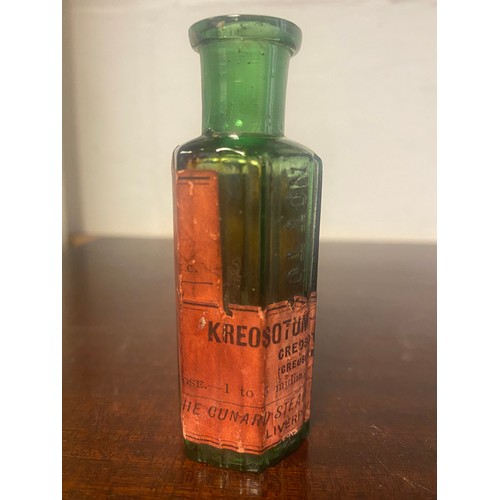 159 - Of Cunard interest: a small green apothecary/chemist bottle, labelled for The Cunard Steam Ship Co -