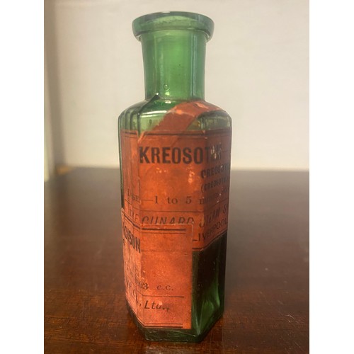 159 - Of Cunard interest: a small green apothecary/chemist bottle, labelled for The Cunard Steam Ship Co -