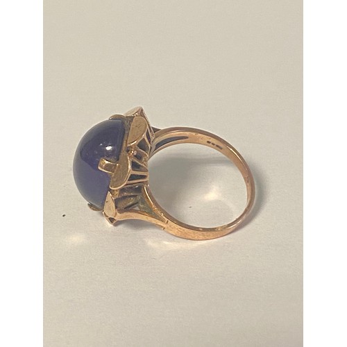 24 - An amethyst dress ring, the large oval amethyst cabochon in 9ct gold mount -