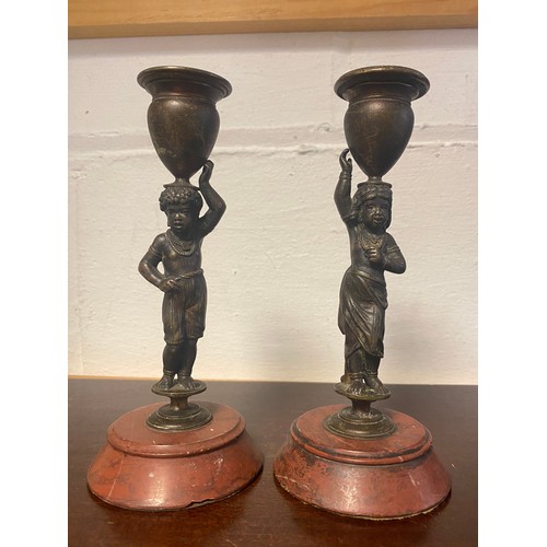 60 - A pair of bronze figural candlesticks, on circular base -