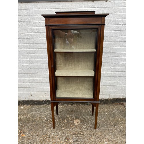 298 - An Edwardian display cabinet, with single glazed door, with lined shelves and tapering legs -