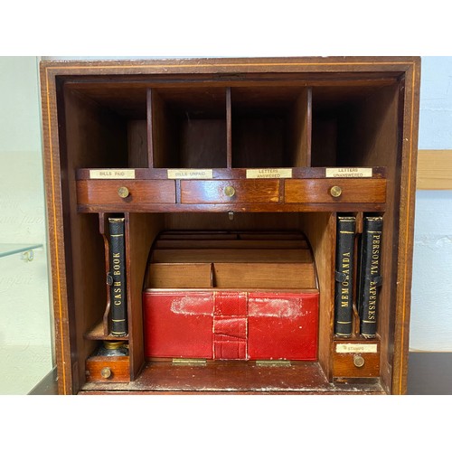 47 - An early 20th century table top stationery cabinet, the front with inlaid decoration and opening to ... 