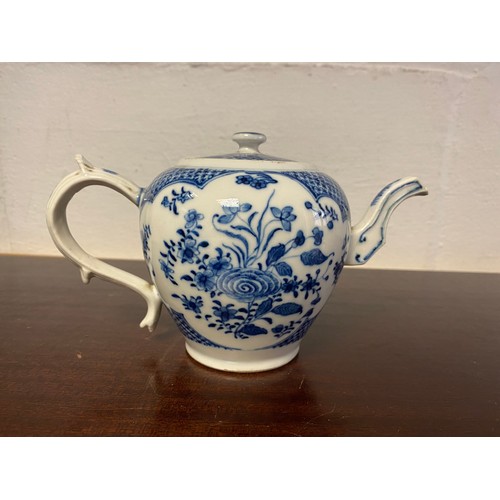 91 - A late 18th/early 19th century blue and white teapot and cover, painted with panels of flowers -