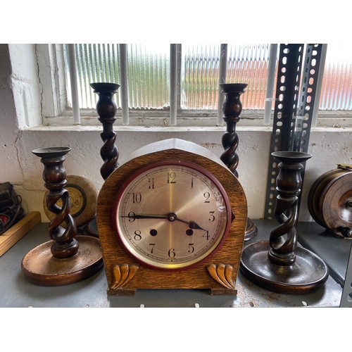 174 - Two pairs of carved candlesticks and an oak cased clock -