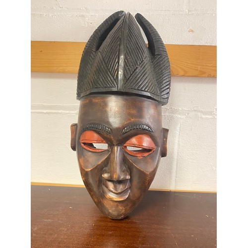 238 - A carved and stained African mask -