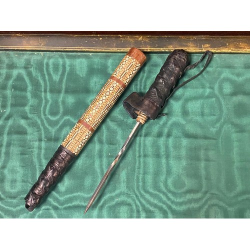 413 - A Middle Eastern dagger, in inlaid scabbard -