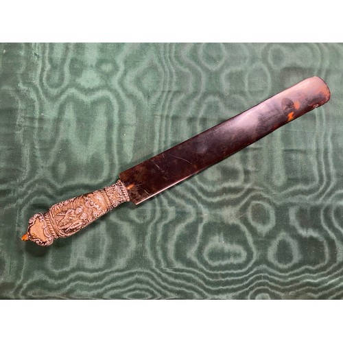 84 - An Edwardian tortoiseshell paper knife, with white metal blade -