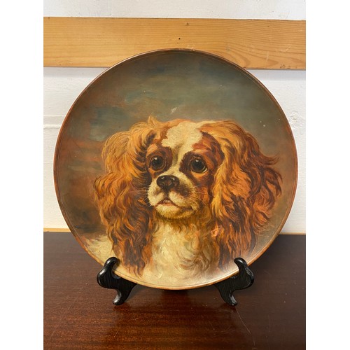 110 - A Watcombe Pottery plate, painted with the head of a King Charles Spaniel -