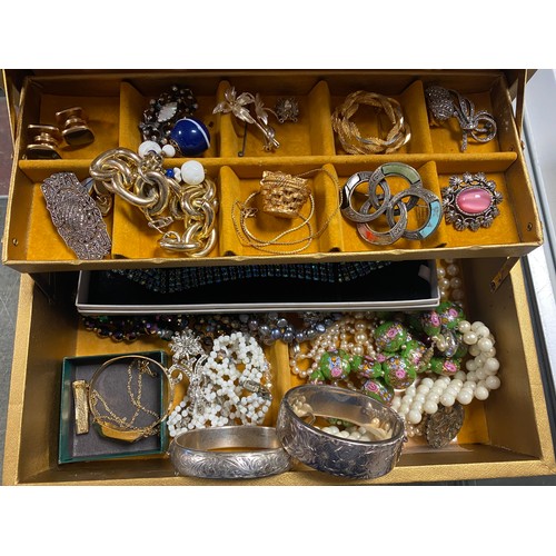 49 - A jewellery box, containing two silver bangles and assorted costume jewellery -