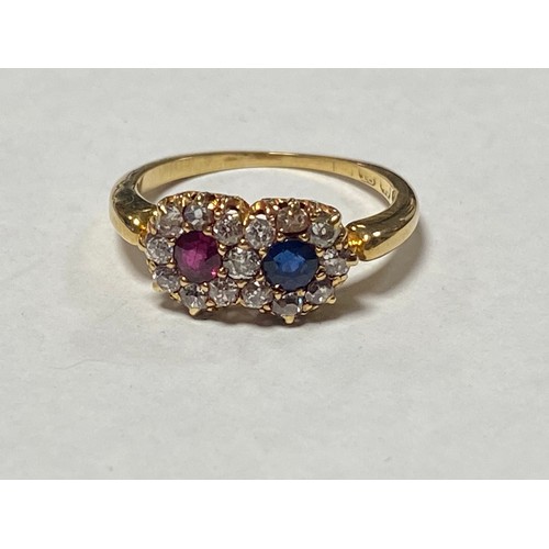 55 - An Edwardian sapphire, ruby and diamond ring, of double cluster design and set in 18ct gold -