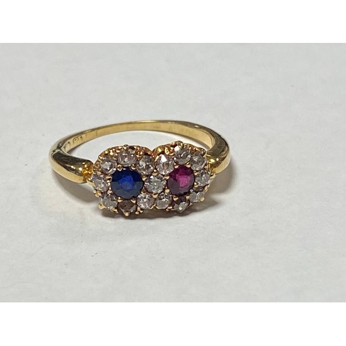 55 - An Edwardian sapphire, ruby and diamond ring, of double cluster design and set in 18ct gold -