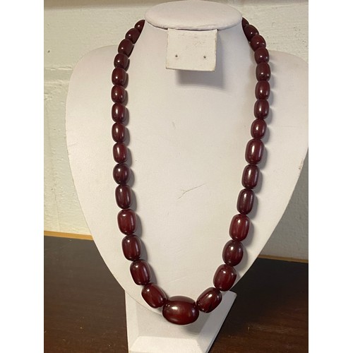 62 - A graduated single row of cherry amber style beads -