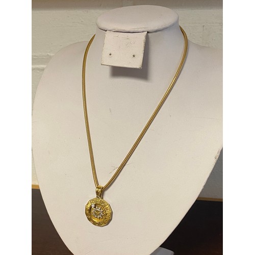 64 - An Italian gold and diamond set adjustable astrological pendant, stamped 750, on a similar chain, al... 