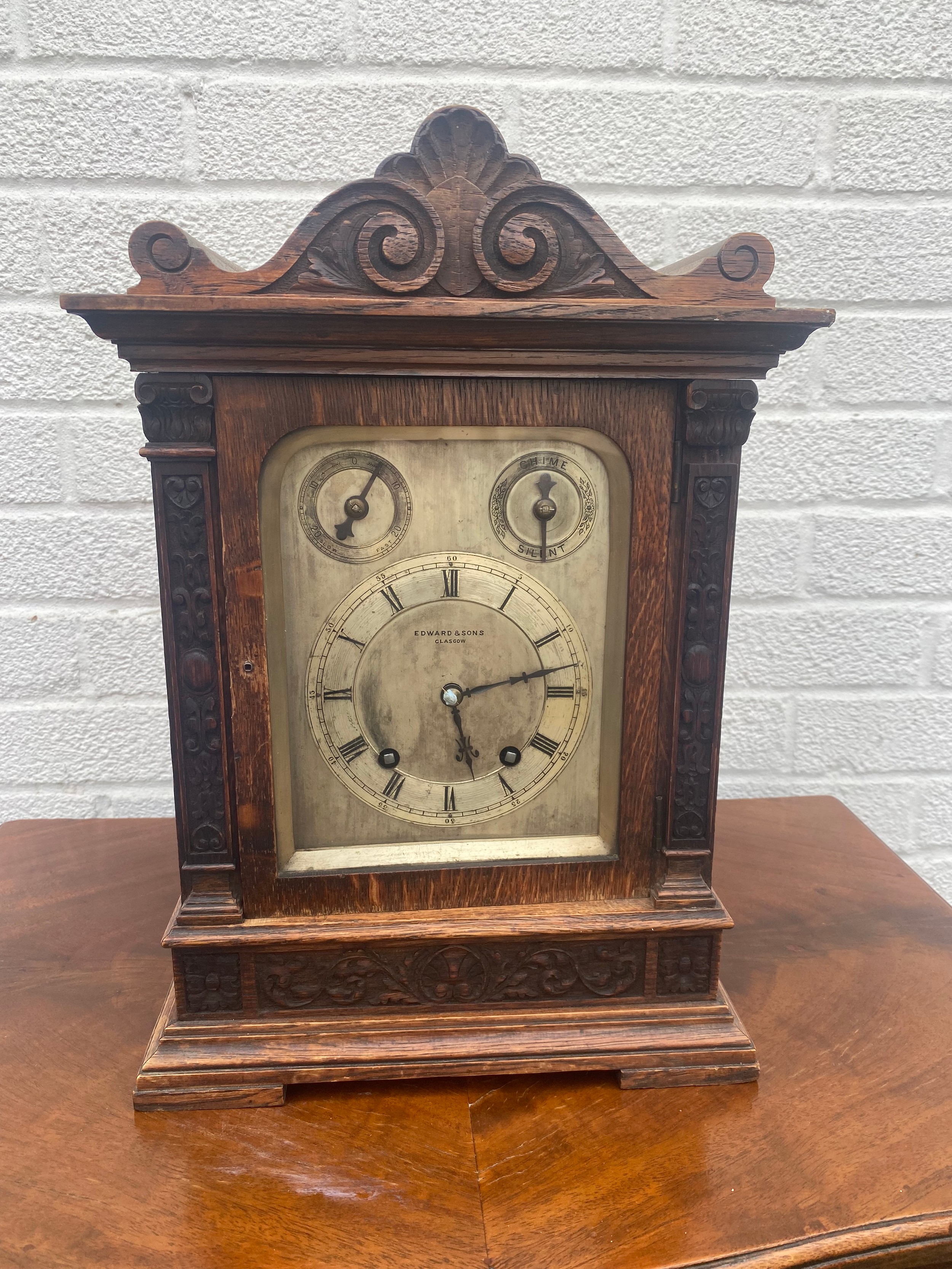 An oak cased mantel clock, signed for Edward & Sons, Glasgow