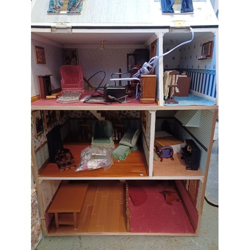 272 - A modern three storey dolls house, with electric and some furnishings -