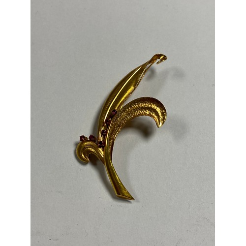 1 - A 14ct gold brooch, of leaf design and set with six small rubies -