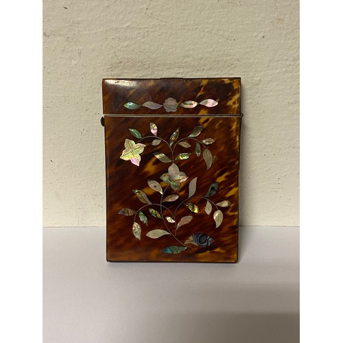 123 - A 19th century tortoiseshell and mother-of-pearl inlaid card case, inlaid in a floral/foliate patter... 