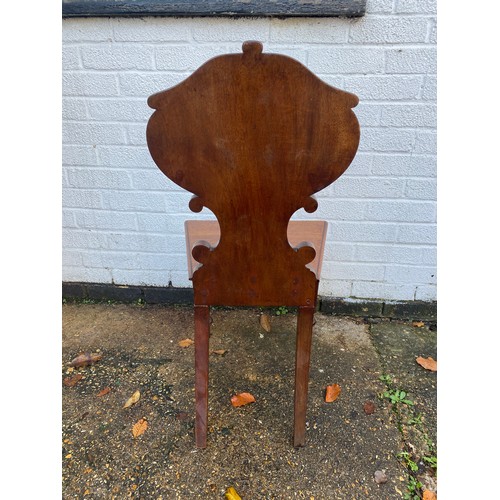 393 - A 19th century mahogany hall chair, with 'C' scroll detail and solid seat, together with another 19t... 