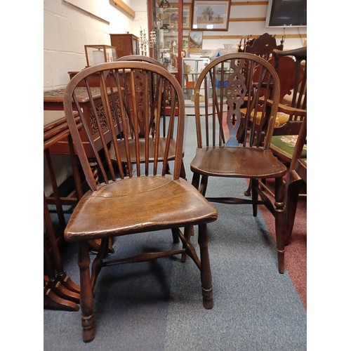 423 - An elm seated stick back chair and a pair of wheelback chairs -