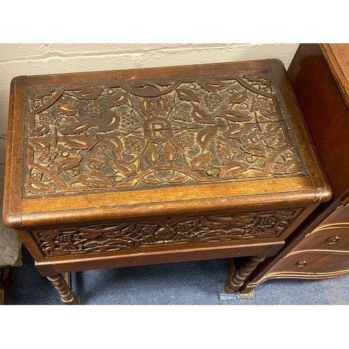 432 - A carved oak chest on stand, the lift top carved with fruiting vines, on barleytwist legs -