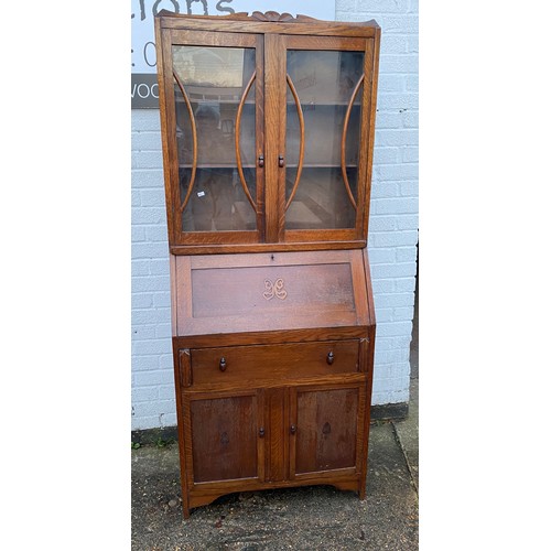 446 - An oak bureau bookcase, the glazed top over fall front, drawer and cupboard doors -