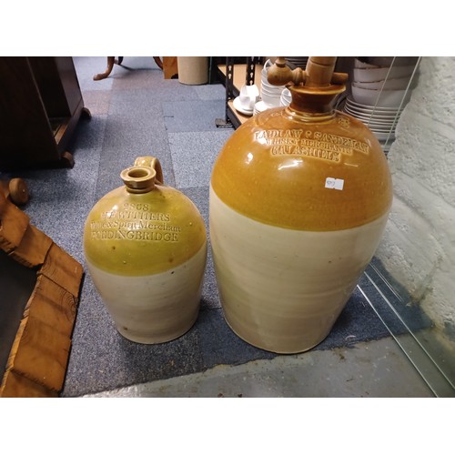 470 - A stoneware flagon, marked for H E Withers of Fordingbridge, and another for Laidlaw & Sandeman, Gal... 