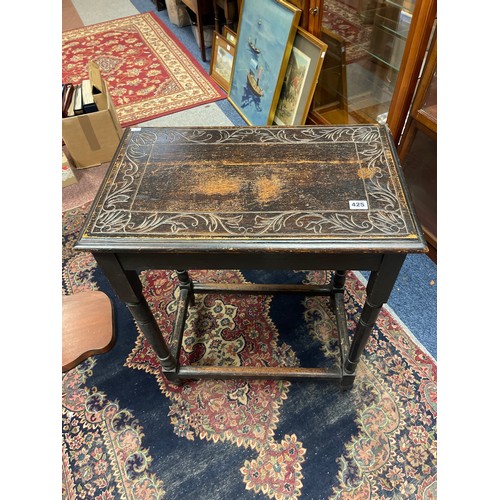 425 - A carved oak side table -