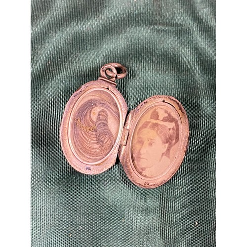 4 - A 19th century white metal and niello locket, oval and inset with hairwork and picture -