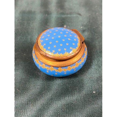 148 - A 19th century French enamel pill box, with gold star decoration on a blue ground -