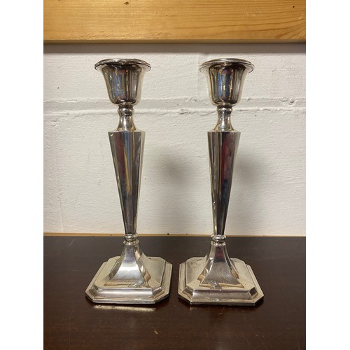 14 - A pair of early 20th century filled silver candlesticks, Birmingham 1913, with tapering stems -