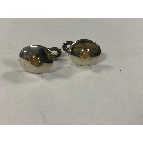 23 - A pair of Georg Jensen silver cufflinks, each oval with inset stone, signed -