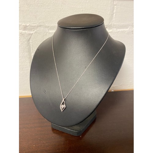 42 - A modern silver and diamond pendant on chain -