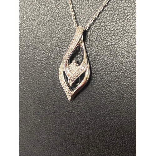 42 - A modern silver and diamond pendant on chain -