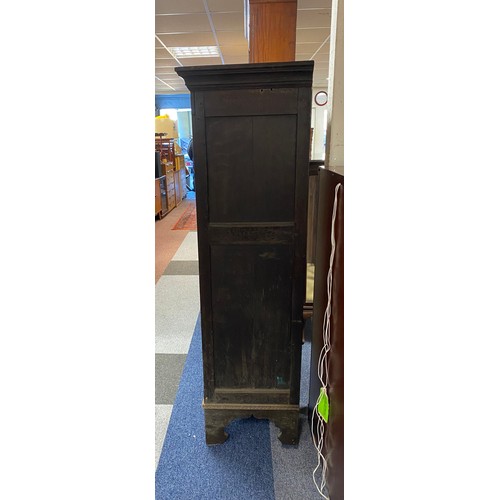 390 - An antique oak cupboard, with two carved doors enclosing shelves and bracket feet -