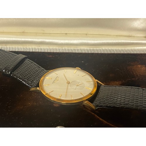 67 - A gent's 9ct gold cased Longines watch, the signed dial with subsidiary dial, to leather strap, boxe... 