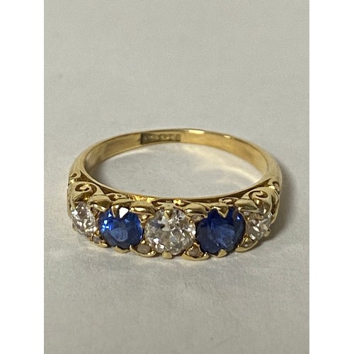 85 - A sapphire and diamond five stone ring, set with alternating old cut diamonds and round cut sapphire... 