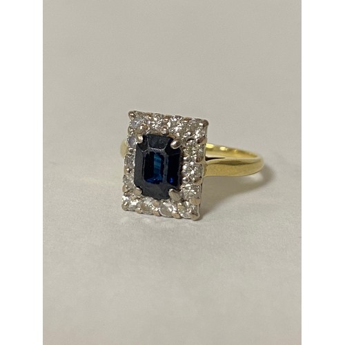 90 - A sapphire and diamond cluster ring, set with a rectangular sapphire in a border of diamonds, set in... 