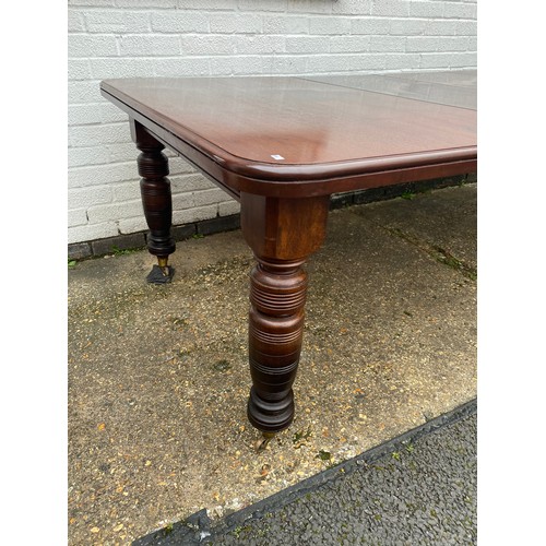 457 - A Victorian mahogany extending dining table, the top with two extra leaves, on ring turned tapering ... 