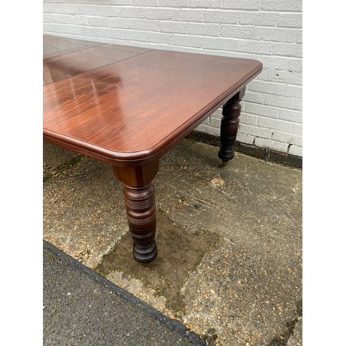 457 - A Victorian mahogany extending dining table, the top with two extra leaves, on ring turned tapering ... 