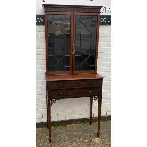 461 - A reproduction Chippendale style display cabinet on stand, with fretwork frieze and detail to drawer... 