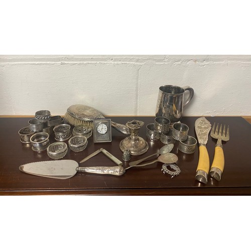 25 - A small quantity of silver and plated wares, to include silver backed brush, silver napkin rings, si... 