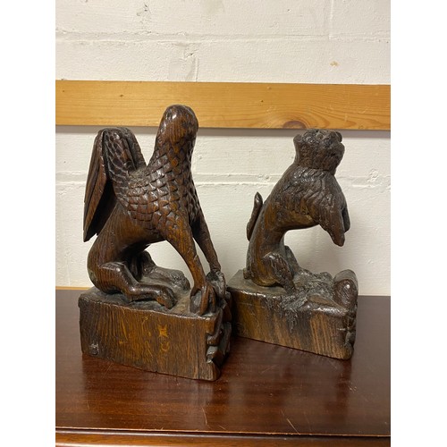 107 - A pair of antique oak carvings of mythical beasts -