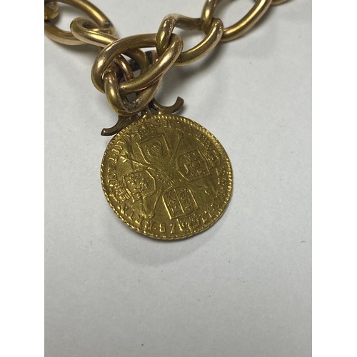 60 - A yellow metal chain, with 9ct gold dog clip, suspending an 1802 George III half guinea and two othe... 