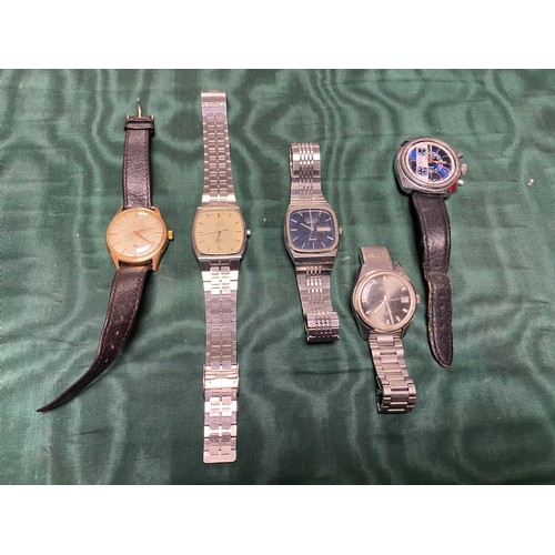 64 - A small mixed group of watches, including a gent's steel cased watch signed Omega -