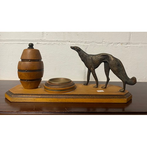 167 - An Art Deco smokers compendium, with standing hound, turned tobacco jar and copper ashtray -