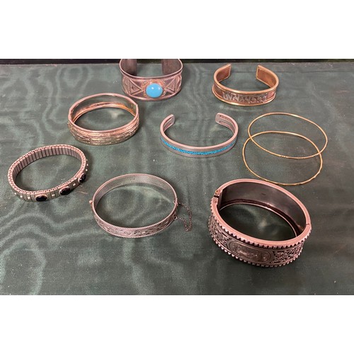 11 - An  Aesthetic style silver hinged bangle, together with another silver bangle and assorted others -