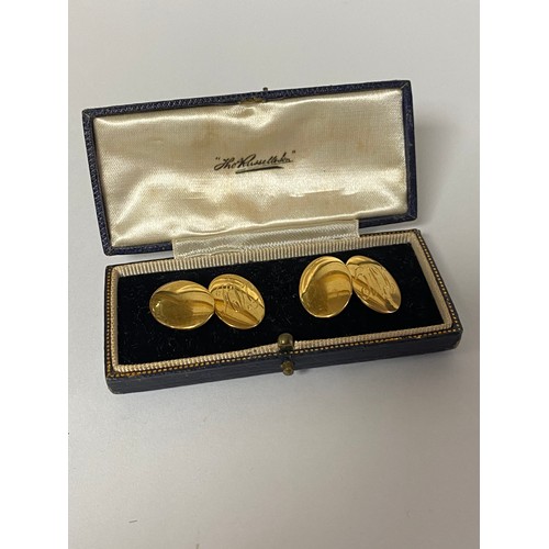 14 - A pair of 18ct gold cufflinks, with oval terminals, initialled -