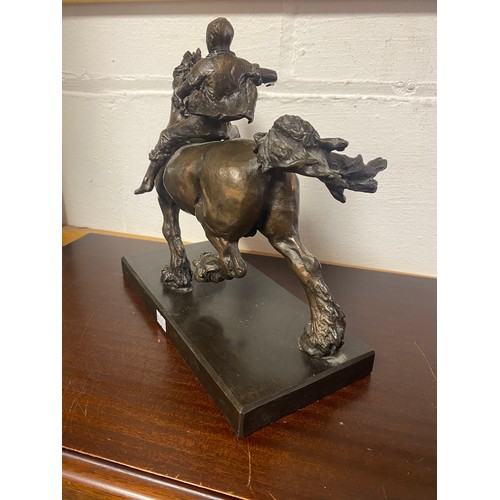 54 - A modern bronze of a boy riding a horse -