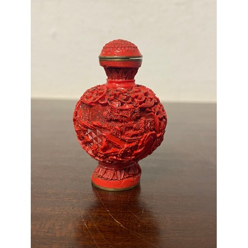 58 - A Chinese cinnabar lacquer snuff bottle, continuously carved with figures in a landscape, four chara... 