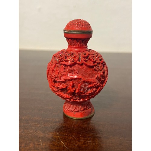 58 - A Chinese cinnabar lacquer snuff bottle, continuously carved with figures in a landscape, four chara... 